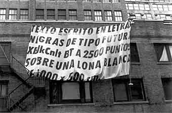 Santiago Sierra, Canvas measuring 1000 x 500 cm. suspended from the front of a building, 1997